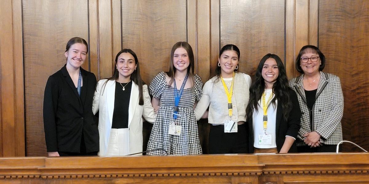 photo (L to R): Isabel Belina, Anna Zuber, Bethany Budell, Daniela Cortes, and Jaquelin Luna with Judge Riko Bishop.