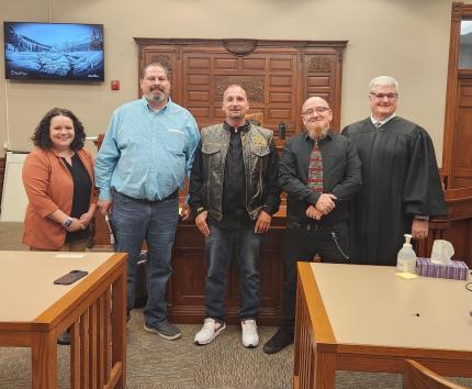 Photo (L to R): Treatment Officer Courtney Elliott, graduates Remus, Brian, and Kevin, with Judge Michael A. Smith.