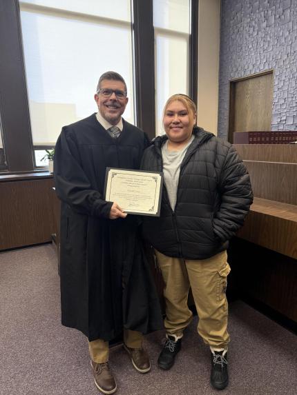 Photo: Judge James Masteller with graduate Tyshall.