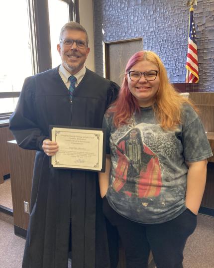 Photo: Judge James Masteller with graduate Angelique.