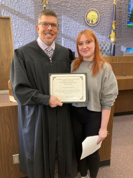 Photo L to R: Judge James Masteller with graduate Delaney.