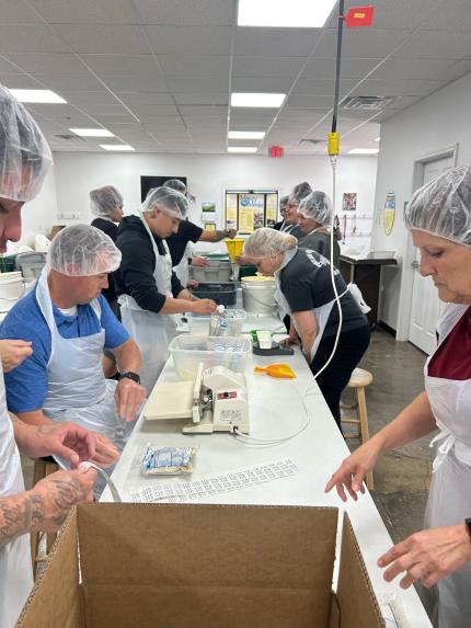 Members of the Northeast Nebraska Adult Drug Court collaborated to pack meals for distribution.