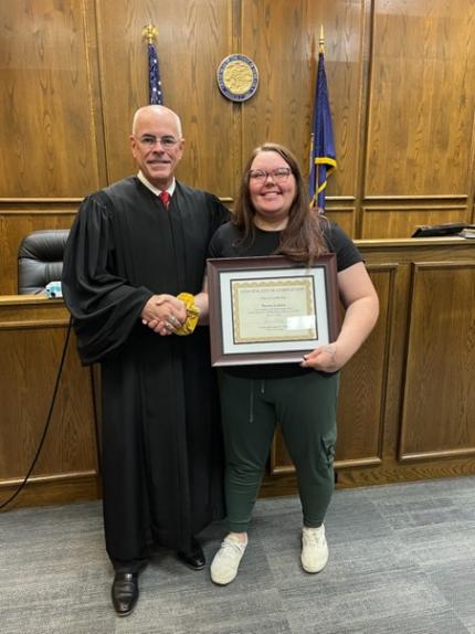 Photo: Judge James Kube with graduate Marisa