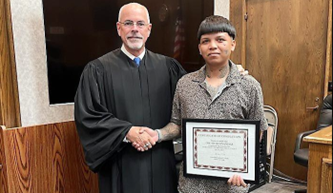 Photo: Judge James Kube and Oscar (graduate). Photo courtesy of Norfolk Daily News.