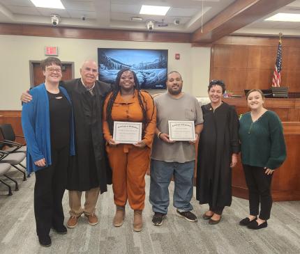 Photo L to R: Treatment Officer Amanda Fouts, Judge Robert Wester, graduate Amber, graduate Joe, Judge Stefanie Martinez, and Assistant Probation Officer Erin Bennett.