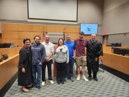 Photo, from left: Judge Stefanie Martinez, graduates Matt, Jason, Kara, John, Caleum, and Judge Robert Wester. 