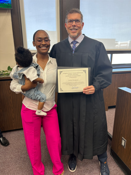 photo: Judge James Masteller with graduate Jackael.