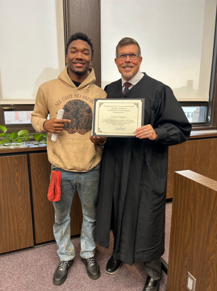 Top photo: Judge James Masteller with graduate Keshaun.