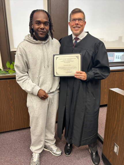 Bottom photo: Judge James Masteller with graduate Mohamed.