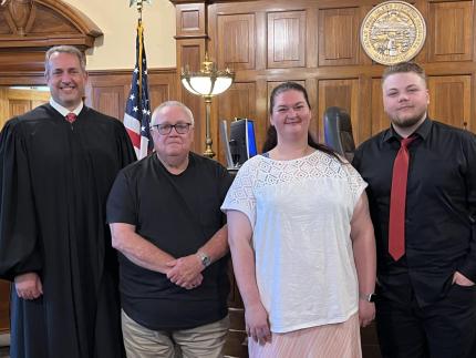 Photo: (L to R) Judge David Bargen and graduates Dale, Ashley, and Marcus.