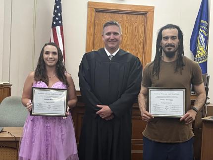 Photo: Judge Richard Smith with graduates Meadow and Joshua.